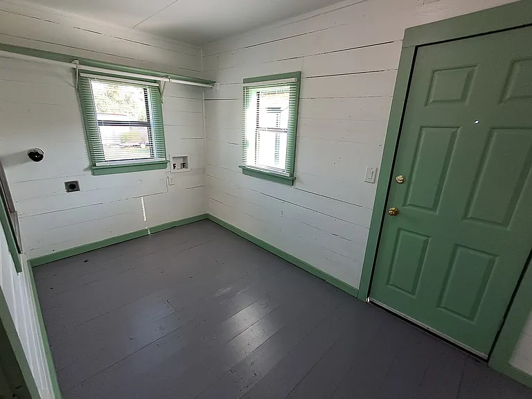 Utility Room with washer/dryer hookups. shelf, and back door