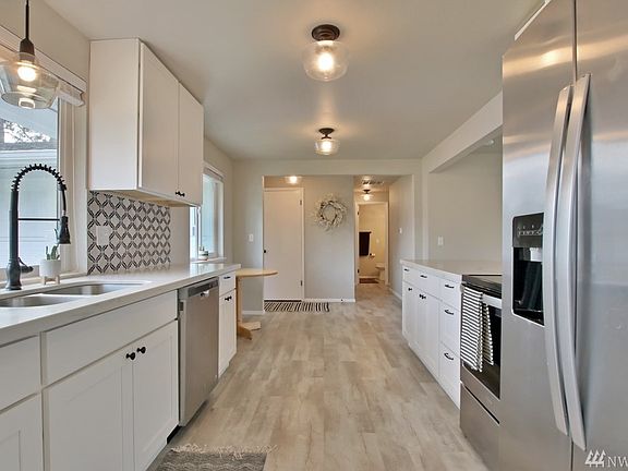 Amazing Kitchen with Quartz Counters, Designer Backsplash, & Stainless Steel Appliances