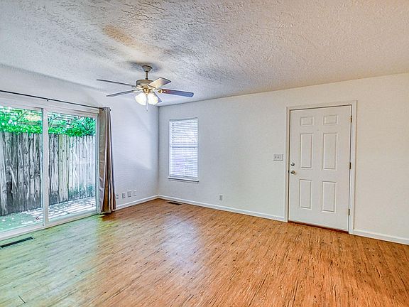 Living room with front door and patio doors to backyard shown