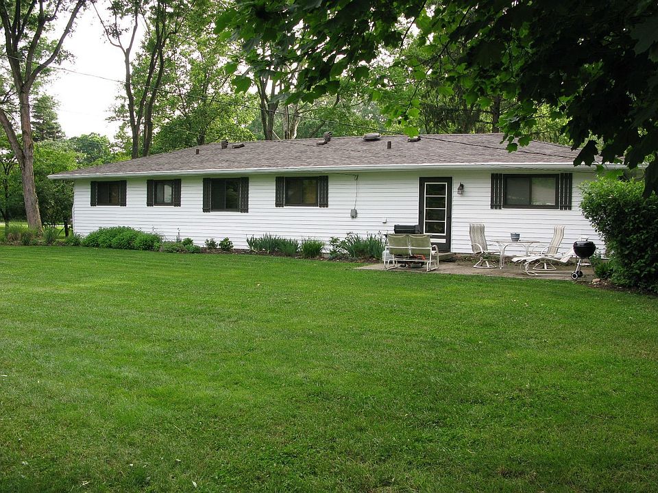 Expansive back yard with an abundance of flowers & patio for outdoor grilling