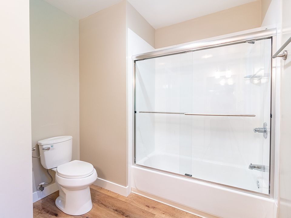 Spacious bathroom with pristine glass sliding door