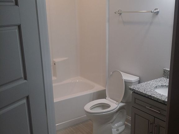 private master bathroom with granite vanity.