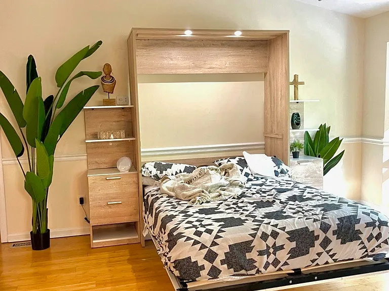Queen Murphy Bed Included (Pulled Down or Up) in Living Room area. Can be used for guests. It is a Queen size mattress. Fold upward when not in use. Can be used just for Decor and Shelving.