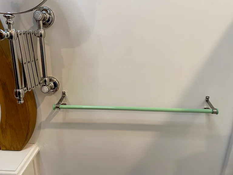 Vintage Chrome Accordion Shaving Mirror & Antique green Jadeite DG Towel Bar above wicker Hamper