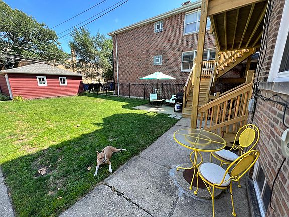 Large fenced in yard with a patio