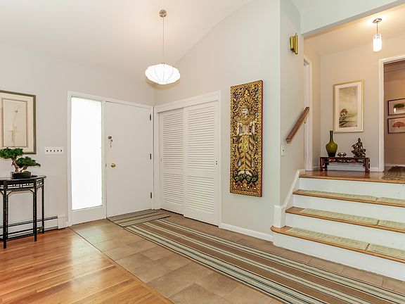 Open entry with vaulted ceiling. Note wide staircase.