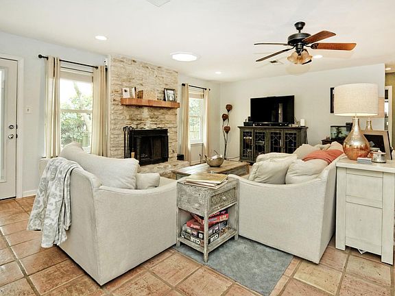 Living room features skylight and fireplace