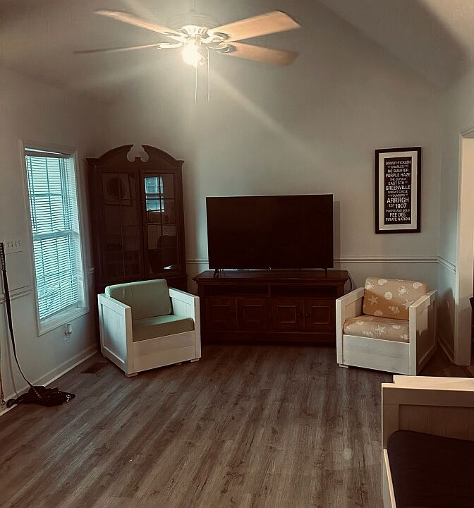 Living room is large with a vaulted ceiling