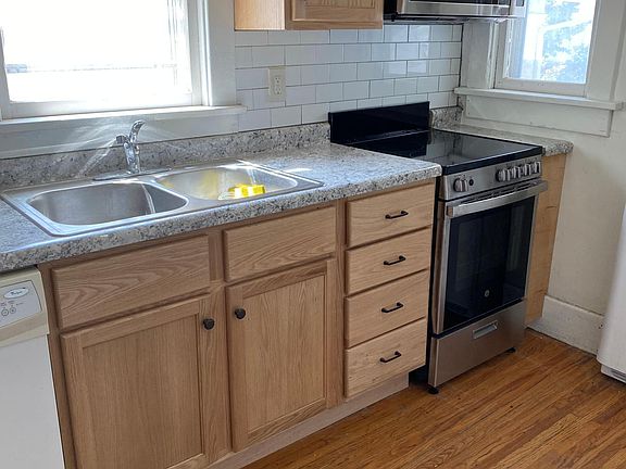 Brand new oak cupboards , countertops and subway tile. New stainless steel sink, microwave and stove