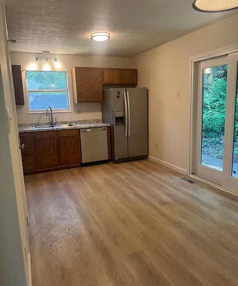 Kitchen with sliding glass door to patio and deck