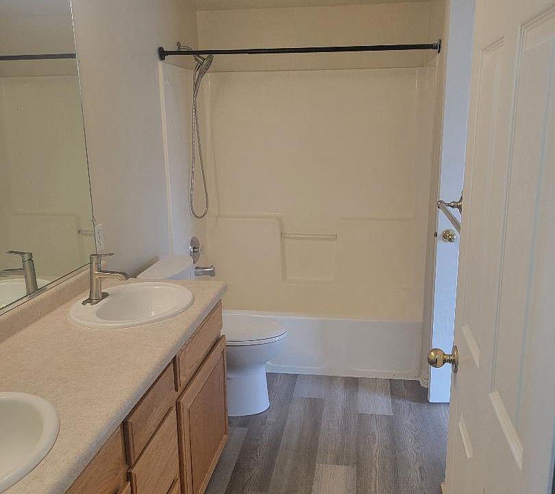 Bathroom with double sink and door in Master Bedroom as well as hall.