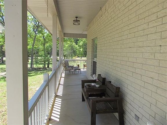 Front porch from front entry wraps around to side of home.