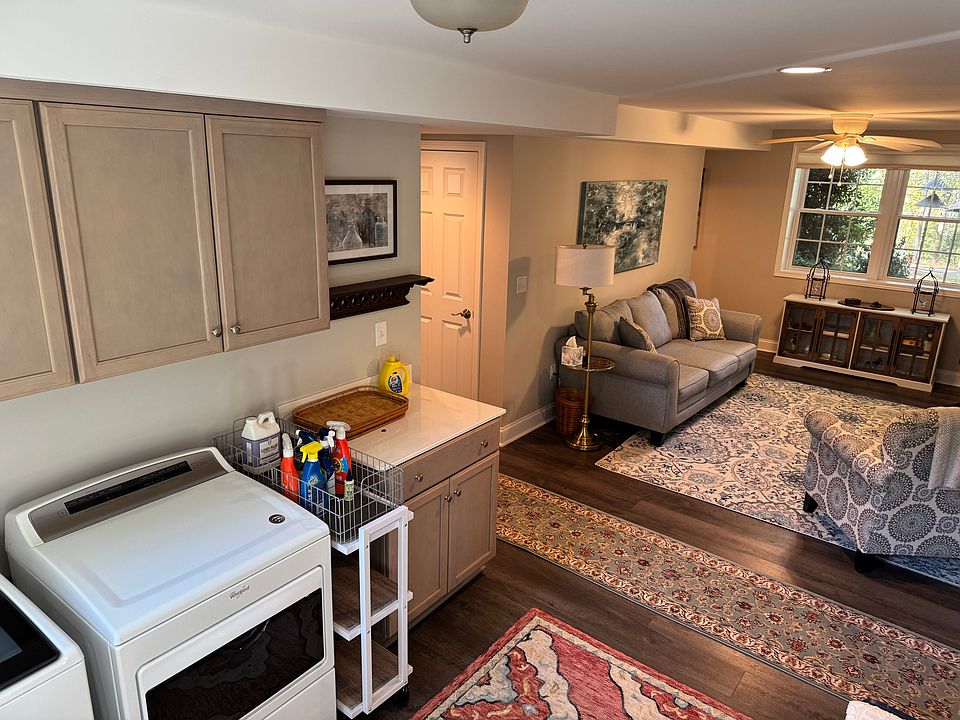 Unit includes both a living room with large sunny windows and an adjoining laundry area with washer/dryer provided.