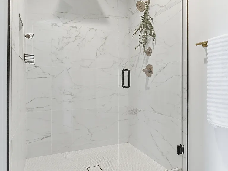 Enjoy a walk-in shower designed with added privacy for a truly relaxing experience.
