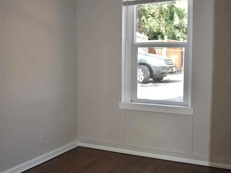 Hardwood floors run from the living room into the bedroom and oversized closet.