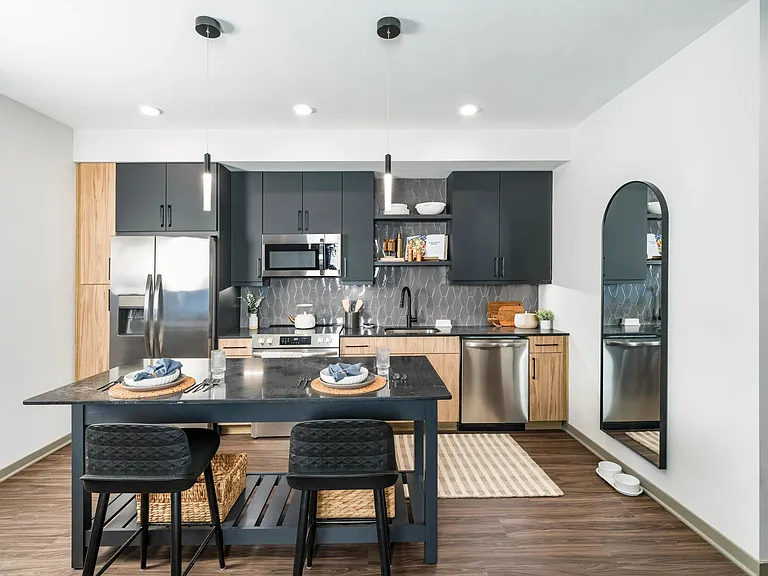 Multiple finish options - this two-tone kitchen features sleek matte black finishes, natural wood accents, and modern open shelving.
