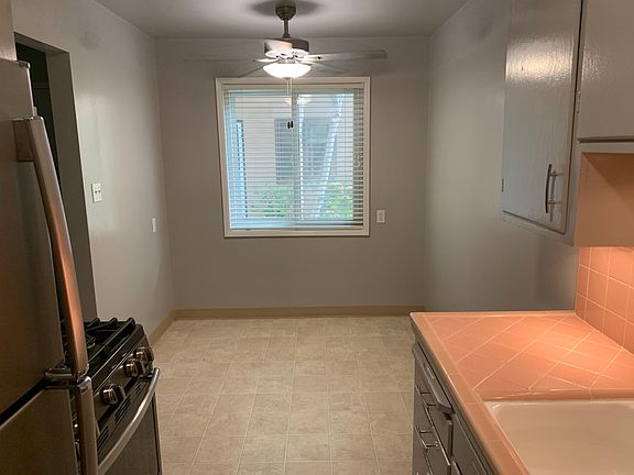 Dining area in a similar apartment that has the original tile counter, included to show the space available.