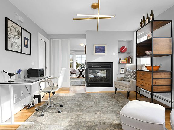 Living room - includes three-sided gas fireplace and large bay window overlooking expansive water views