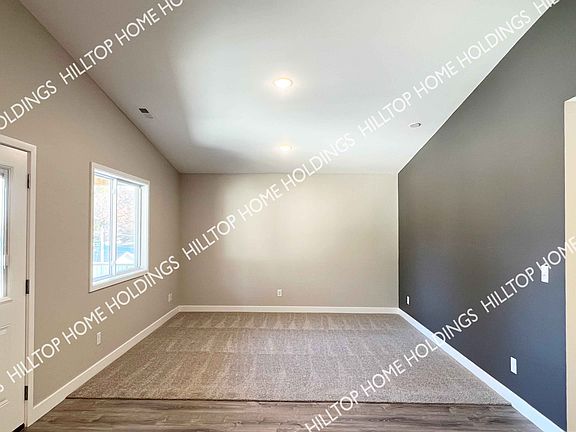 Living room. This unit is still under construction. Photo of neighboring unit with similar finishes.