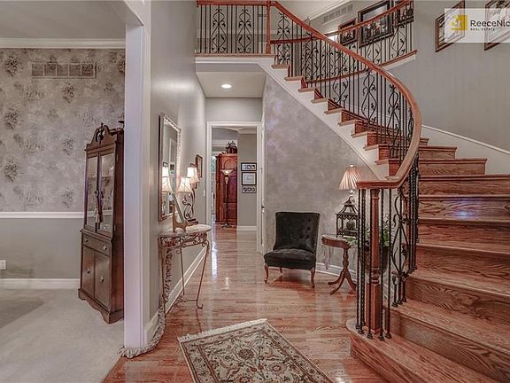 Make a grand entrance! Open and bright entry into you new home. Beautiful solid wood stair case with iron spindles. Office to the right - Dinning to the left.