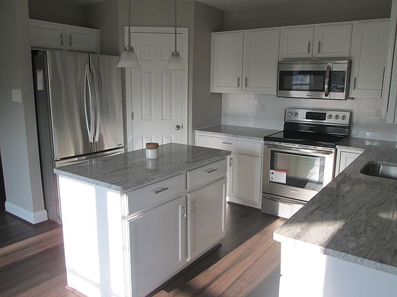 Kitchen with Stainless Steel Appliances, Granite Countertops, Tile Backsplash