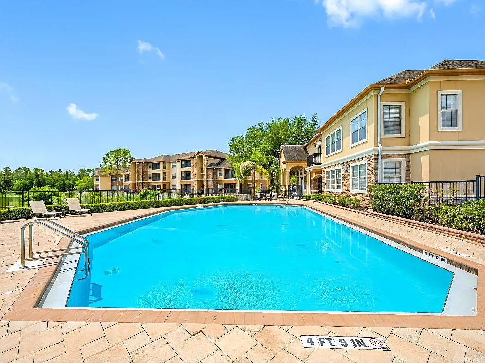 A clean, well-maintained pool with crystal-clear water_ perfect for swimming, relaxing, or sunbathing. Features include a spacious deck, lounge chairs, and both shallow and deep areas for all ages.