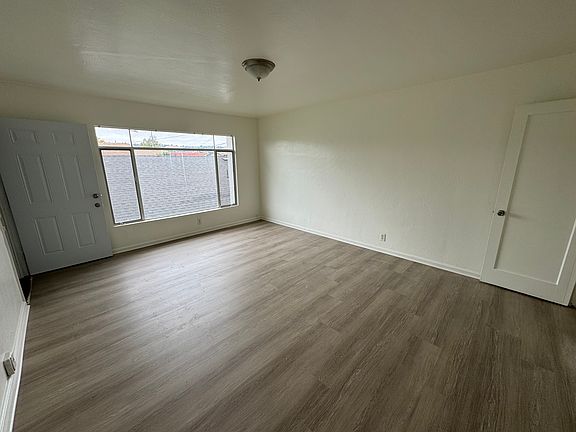 Living Room with new flooring and Large window with mountain view