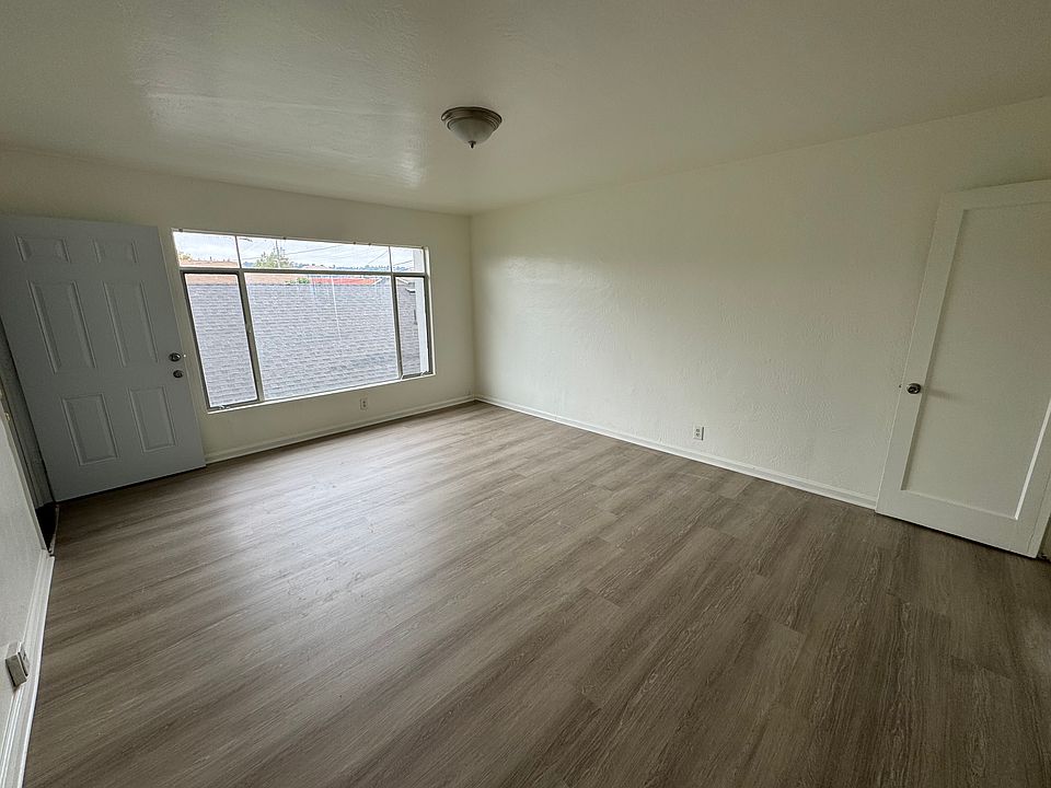 Living Room with new flooring and Large window with mountain view