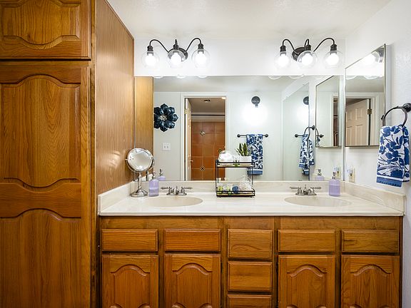 Dual vanity bathroom with lots of light and mirrors