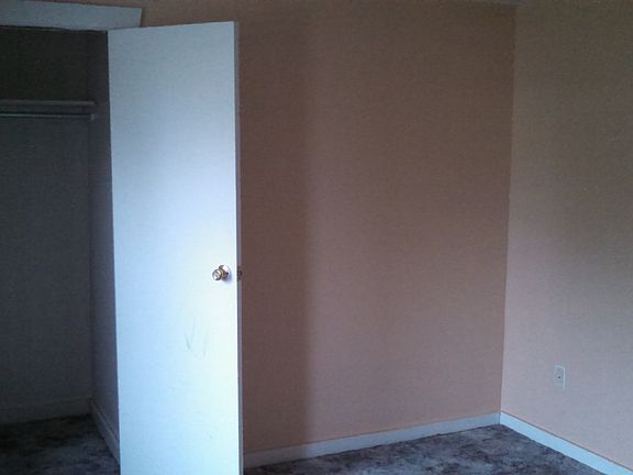 Bedroom with attached closet. Double windows in bedroom faci
