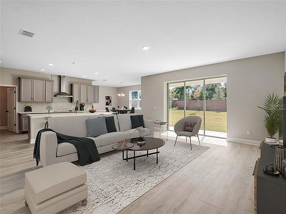 Virtually staged family room open to the kitchen