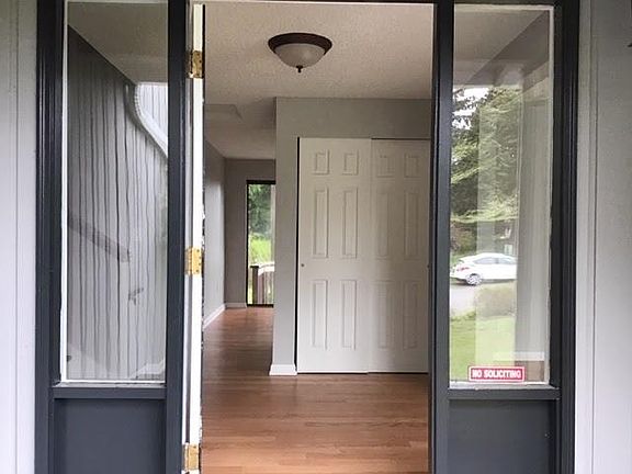 Entry way. Black painted door with grey exterior.