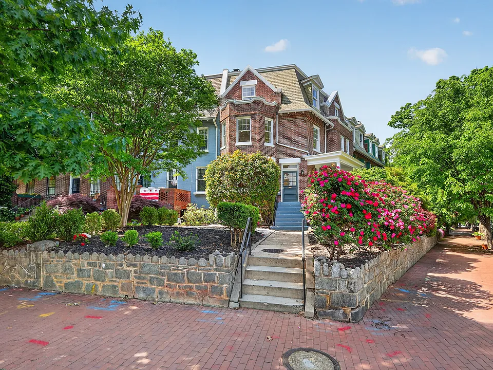 View of property from Maryland Ave, Beautiful mature rose bushes in full bloom.