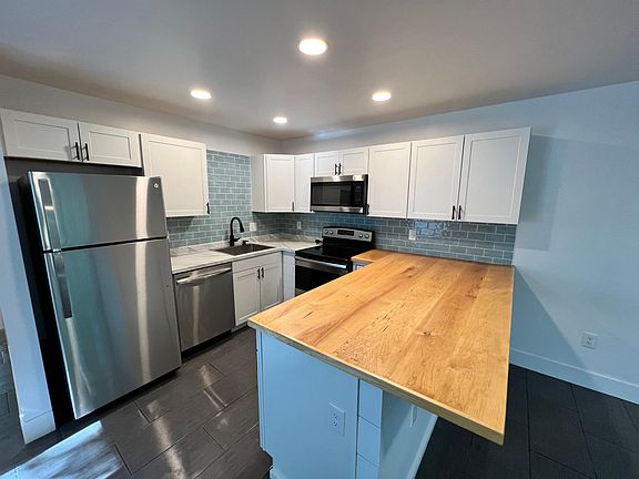 Butcher block countertop and Glass tile backsplash
