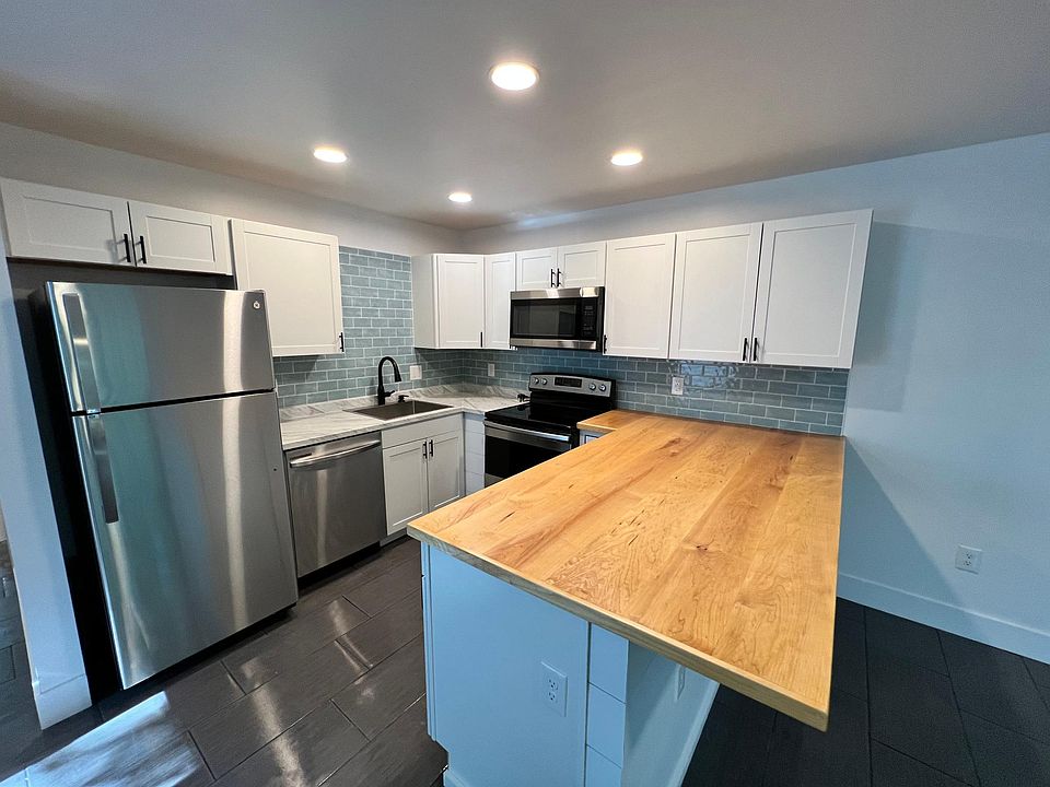 Butcher block countertop and Glass tile backsplash