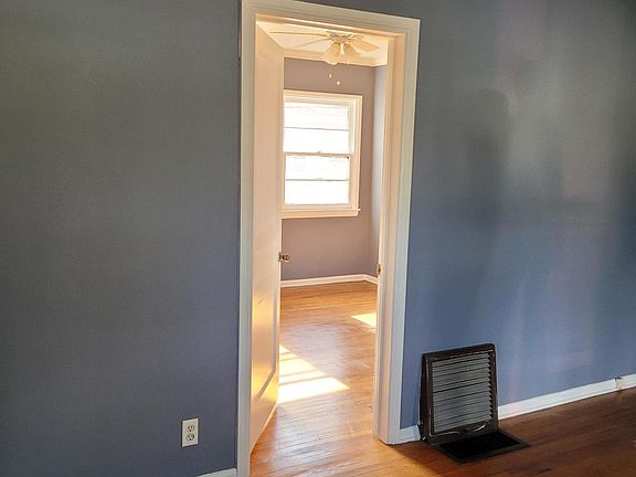 entrance to bedroom with window air conditioner & walk-in closet