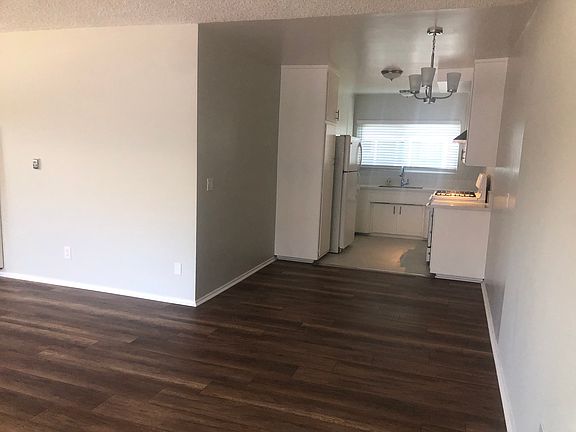 Charming kitchen with gas stove and white cabinets