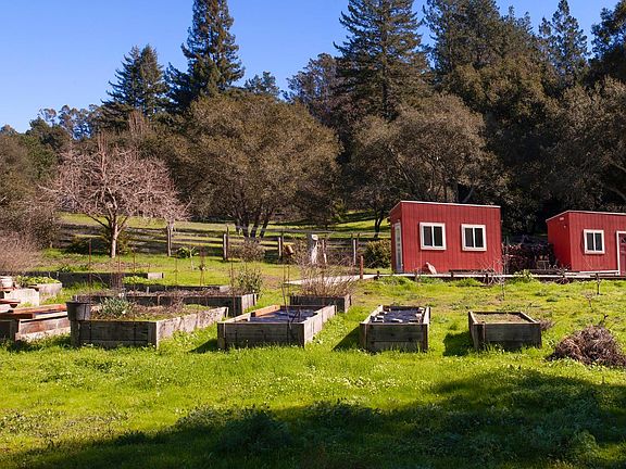 Raised planter boxes protected by gopher wire.