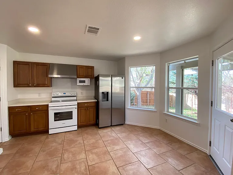 Kitchen with Breakfast Nook - New Samsung Refrigerator