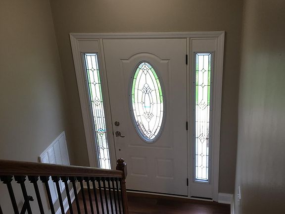 Brand new hardwood staircase and next exterior door. 