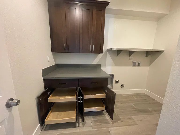 Laundry Room with Folding Area and Cabinets