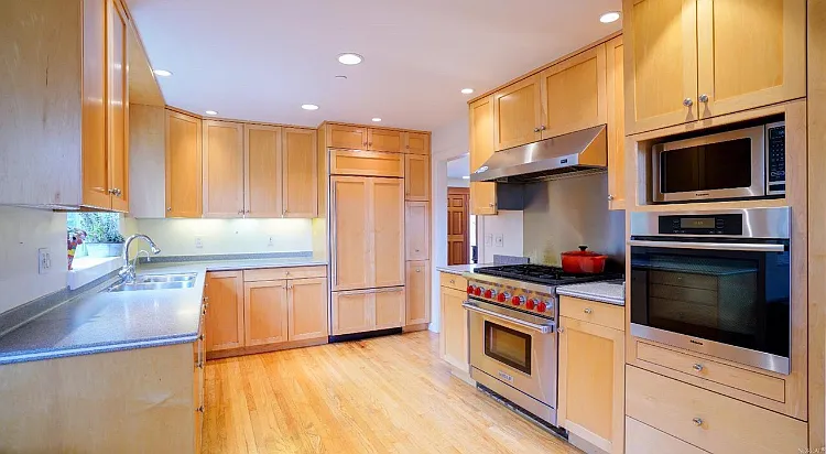 Modern kitchen with professional stove and built-in Sub Zero refrigerator. Quartz counter tops will be newly installed on 7/1.