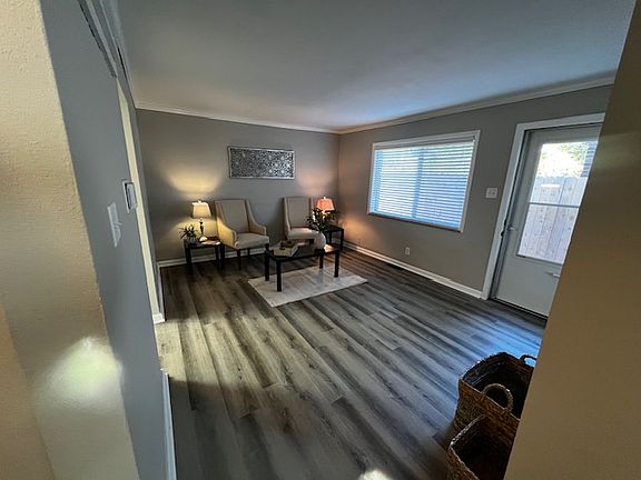 Living room with large thermal insulated windows and 2" blinds on all windows. Brand new vinyl plank flooring, too