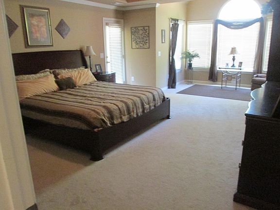 Master with sitting area and door to balcony