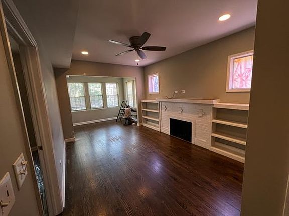 Sunroom and living room, bookshelves, faux fireplace