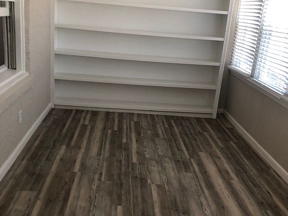 Enclosed front porch, shelves on one wall