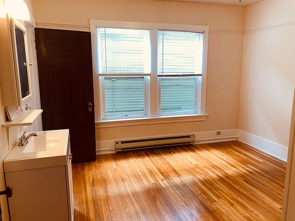 Cozy bedroom with hardwood floors and large insulated windows