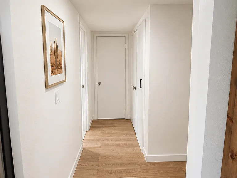 Hallway to downstairs bathroom and 4th bedroom