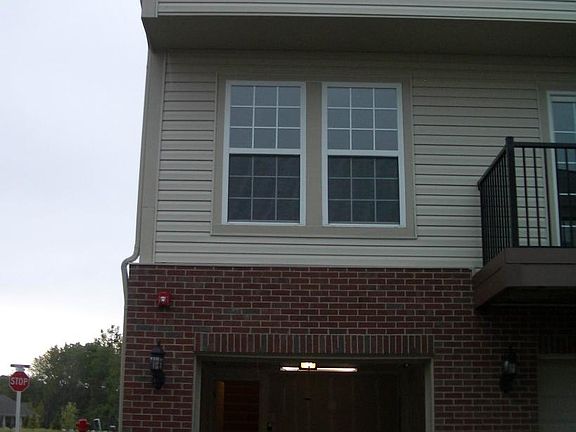 Back of condo with attached 1 car garage