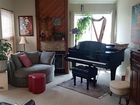Living room with wood-burning fireplace.